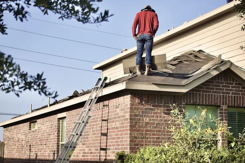 Professional roofer working on a residential roof in Four Mile Village
